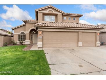 Charming two-story home with a three-car garage and well-maintained lawn in a suburban neighborhood at 5102 E Charleston Ave, Scottsdale, AZ 85254