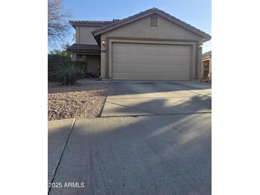 Two-story house with attached garage and driveway at 12701 W Paradise Dr, El Mirage, AZ 85335