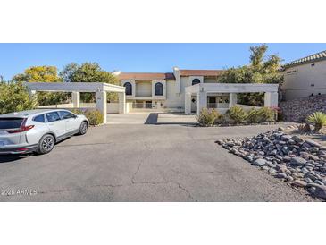 Inviting exterior of a two-story home with a paved driveway and landscaping at 12851 N Mimosa Dr # 102, Fountain Hills, AZ 85268