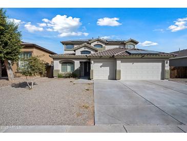 Two-story house with a three-car garage and desert landscaping at 14866 W Windsor Ave, Goodyear, AZ 85395