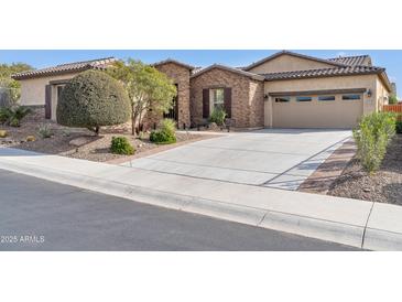 Single-story home with stone accents and a two-car garage at 17531 W Liberty Ln, Goodyear, AZ 85338