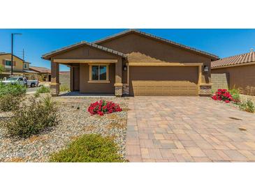 New single-story home with a two-car garage and landscaped front yard at 25838 W Samantha Way, Buckeye, AZ 85326