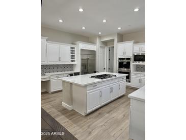 Spacious kitchen boasts white cabinets and a sizable island at 3957 E Expedition Way, Phoenix, AZ 85050