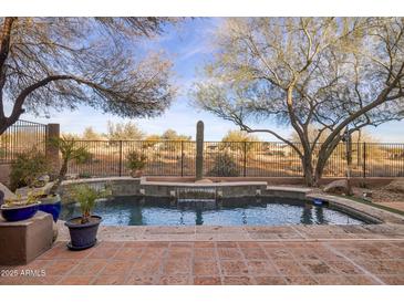 Refreshing swimming pool with waterfall feature at 41007 N Harbour Town Way, Anthem, AZ 85086
