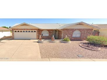 Charming one-story brick house with a well-maintained front yard featuring desert landscaping and a spacious two-car garage at 4742 E Capri Ave, Mesa, AZ 85206