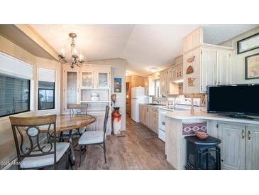 Bright kitchen features ample cabinetry and a dining area at 880 Motherlode Dr # 1099, Apache Junction, AZ 85119