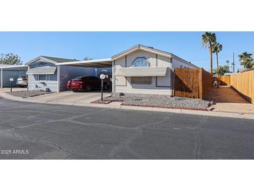 Single-wide manufactured home with carport and fenced yard at 10951 N 91St Ave # 158, Peoria, AZ 85345