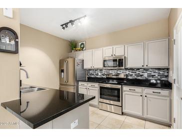 Modern kitchen with stainless steel appliances and granite countertops at 11260 N 92Nd St # 1102, Scottsdale, AZ 85260