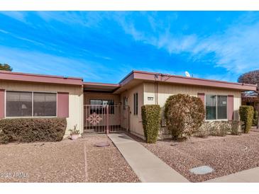 Front view of a single-story home with landscaping and a walkway at 13720 N 98Th Ave # E, Sun City, AZ 85351