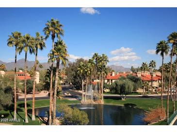Community features lake, fountain, and Spanish-style homes at 9711 E Mountain View Rd # 1545, Scottsdale, AZ 85258