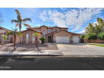 Two-story house with stone accents and a three-car garage at 11405 E Rafael Ave, Mesa, AZ 85212