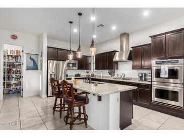 Kitchen with an island, granite countertops, and stainless steel appliances at 3222 S 186Th Ln, Goodyear, AZ 85338