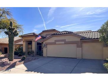 Beautiful desert landscaping and single story home with tile roof and two car garage at 4103 E Montgomery Rd, Cave Creek, AZ 85331