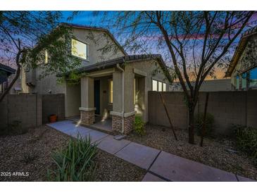 Two-story home with covered entry and landscaped front yard at 5752 W Raymond St, Phoenix, AZ 85043