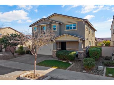 Two-story home with neutral exterior, two-car garage, and landscaping at 9839 E Theia Dr, Mesa, AZ 85212