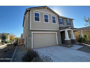 Two-story house with attached garage and neutral color exterior at 10993 W Pierce St, Avondale, AZ 85323