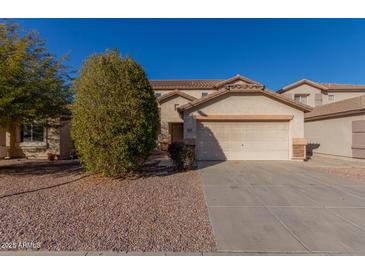 Two-story house with a large driveway and desert landscaping at 11640 W Duran Ave, Youngtown, AZ 85363