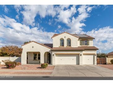 Two-story house with white exterior, three-car garage, and landscaped yard at 12677 N 140Th Dr, Surprise, AZ 85379