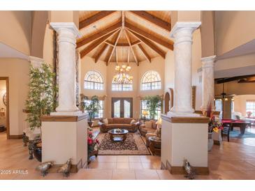 Open living area with high ceilings and a stone fireplace at 15225 N Bluejay Pl, Fountain Hills, AZ 85268