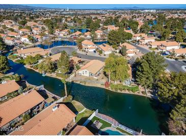 Aerial view of a house near a lake with a community of similar homes at 1610 W Maplewood St, Chandler, AZ 85286