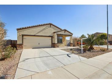 Single-story house with a two-car garage and desert landscaping at 19371 N Nocera Rd, Maricopa, AZ 85138