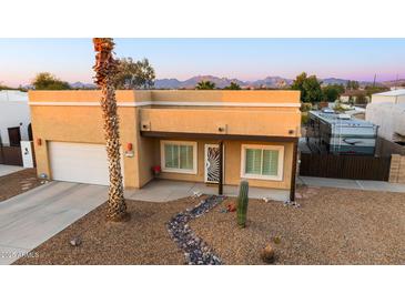 Tan stucco house with a large RV and mountain views at 270 E 13Th Ave, Apache Junction, AZ 85119