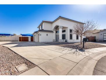 Two-story stucco home with a three-car garage and landscaped front yard at 4333 W Shaw Butte Dr, Glendale, AZ 85304