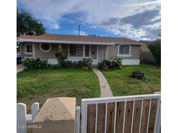 Ranch style home with a well-manicured lawn and gated entry at 4339 W Crittenden Ln, Phoenix, AZ 85031