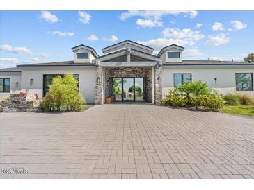 Stunning modern home with brick accents and a large paved driveway at 4602 E Arcadia Ln, Phoenix, AZ 85018