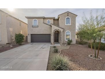 Two-story house with a brown door and landscaped yard at 4933 E Meadow Mist Ln, San Tan Valley, AZ 85140