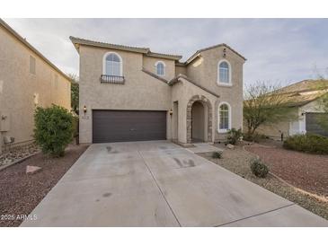 Charming two-story home featuring a well-manicured front yard and a two-car garage, inviting and functional at 4933 E Meadow Mist Ln, San Tan Valley, AZ 85140