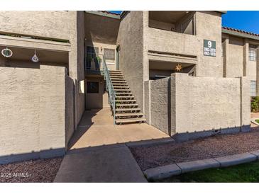 Exterior view of condo building with stairs leading to entrance at 533 W Guadalupe Rd # 1069, Mesa, AZ 85210