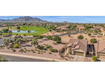 Aerial view of a house and golf course community at 6688 S Cartier Dr, Gilbert, AZ 85298