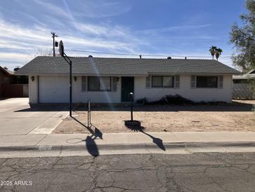 Ranch style home with carport and front yard at 731 E Manor Dr, Casa Grande, AZ 85122