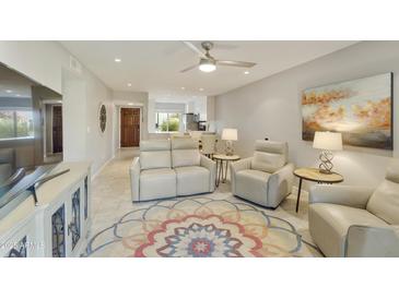 Bright living room with comfy seating and view to kitchen at 7732 E Desert Flower Ave, Mesa, AZ 85208