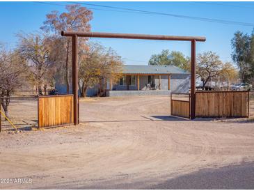 Ranch home with gated entry and rustic accents at 10137 N White Rd, Maricopa, AZ 85139