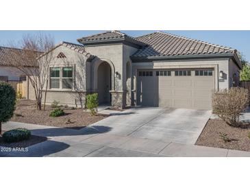 Single-story home with a two-car garage and well-manicured landscaping at 10950 N 184Th Dr, Surprise, AZ 85388