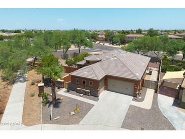 Aerial view of single-story house with desert landscaping, driveway, and two-car garage at 15338 W Montecito Ave, Goodyear, AZ 85395