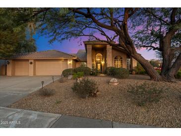 Beautiful desert landscape surrounds this single-story home with a three-car garage at 19275 N 88Th Way, Scottsdale, AZ 85255