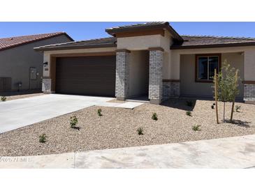 Charming single-Gathering home featuring a two-car garage and low-maintenance desert landscaping at 20634 N 226Th Dr, Surprise, AZ 85387