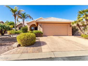 Single-story home with a two-car garage and landscaped front yard at 24502 S Starcrest Dr, Sun Lakes, AZ 85248