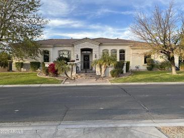 One-story home with stone accents and landscaped yard at 3412 E Indigo Cir, Mesa, AZ 85213