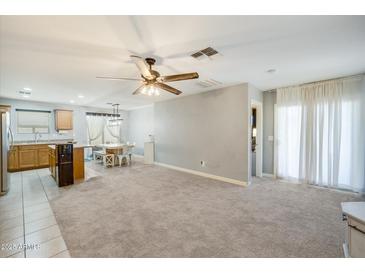 Open living area with kitchen, dining area and access to backyard at 4678 E Jadeite Dr, San Tan Valley, AZ 85143