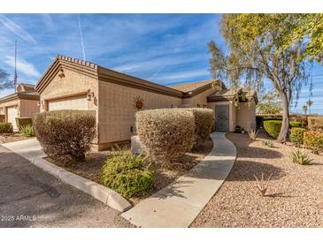 Attractive stucco home with 2-car garage, landscaping, and walkway at 846 N Pueblo Dr # 104, Casa Grande, AZ 85122