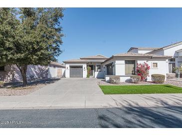 White two-story house with gray garage doors and landscaping at 862 E Gemini Pl, Chandler, AZ 85249