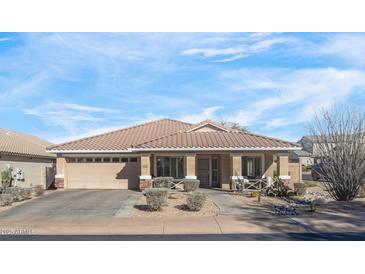 Charming single-story home featuring a tile roof, desert landscaping, and a welcoming front porch area at 9970 E Monte Cristo Ave, Scottsdale, AZ 85260