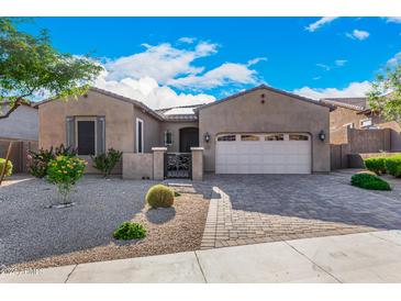 Single-story home with a two-car garage and landscaped front yard at 12064 S 186Th Ave, Goodyear, AZ 85338