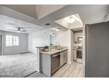 Modern kitchen with stainless steel appliances and granite countertops at 1720 E Thunderbird Rd # 2010, Phoenix, AZ 85022