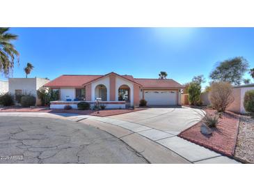 Single-story home with red tile roof, arched entryway, and landscaped front yard at 1745 N Terrace Cir, Casa Grande, AZ 85122