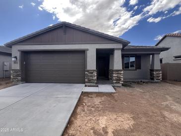 Charming single-story home with a two-car garage and stone accents in a well-planned community at 20612 N 226Th Dr, Surprise, AZ 85387